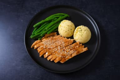 Orange chicken with mashed potatoes and green beans