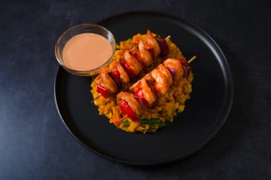 Yellow rice with shrimp skewers