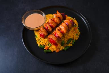 Yellow rice with shrimp skewers