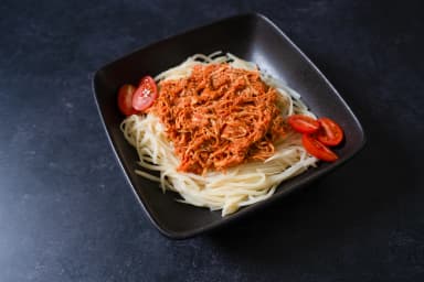 Vegetable pasta with shredded chicken in neapolitan sauce